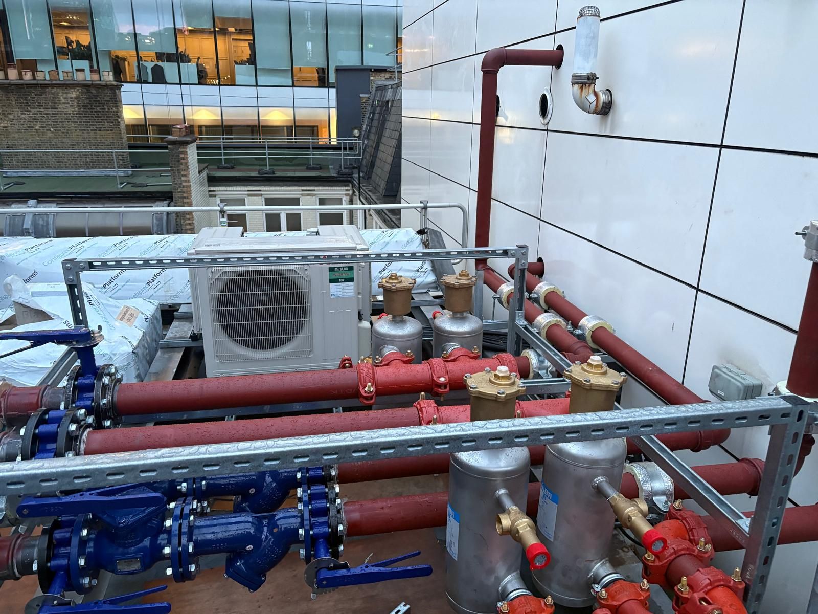 Rooftop commercial mechanical plant installation with valves and pipework